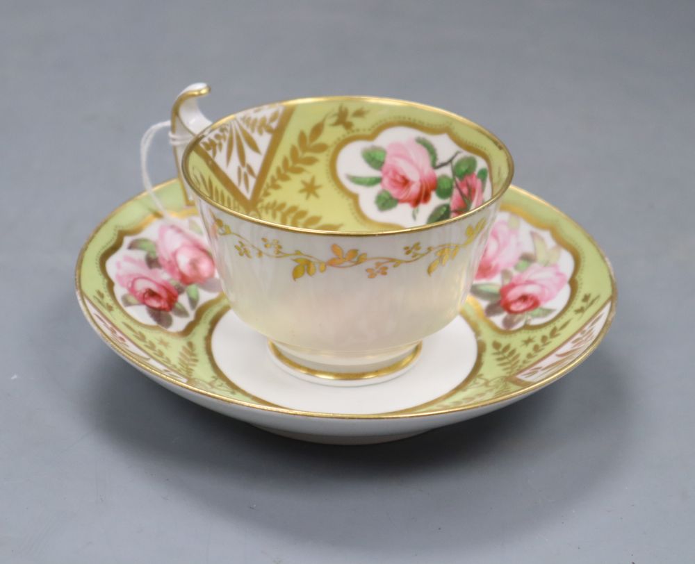 A Spode cup and saucer, painted with pairs of pink rose blooms